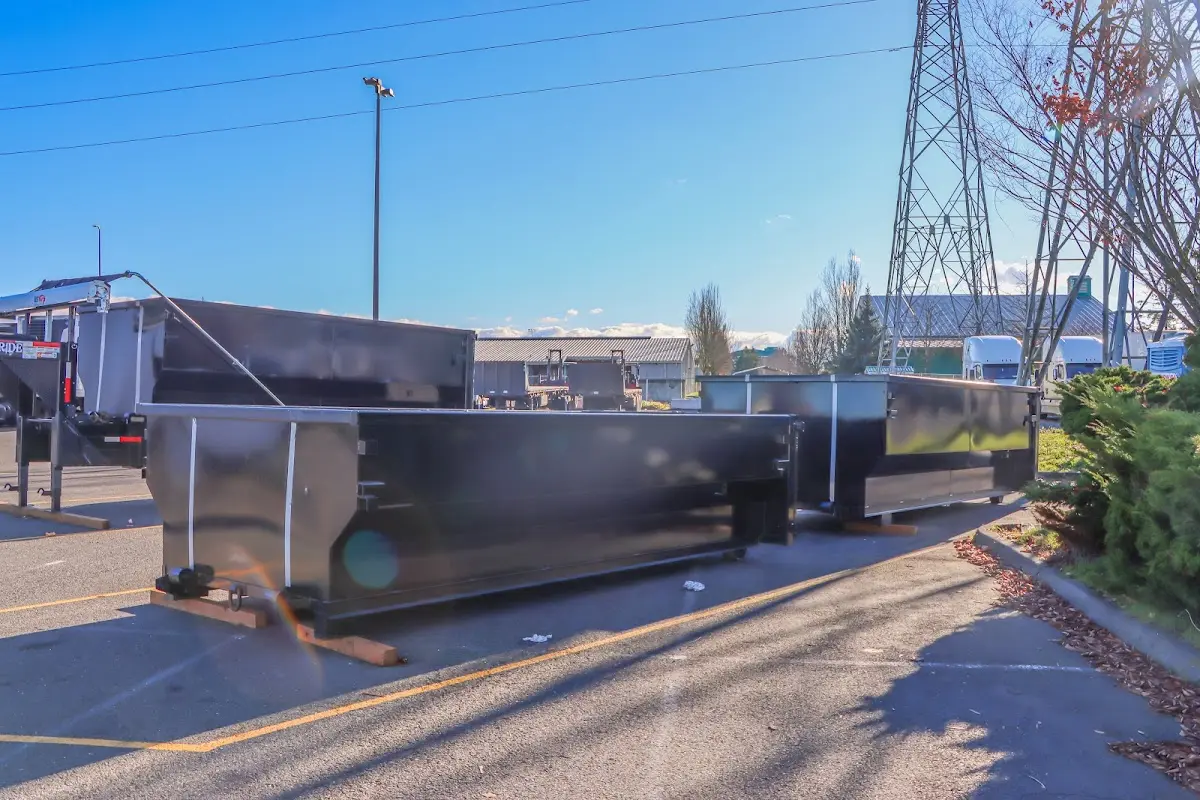 Roll-off dumpster ready for waste disposal at job site for Concrete Dumpster Rental in Greenville